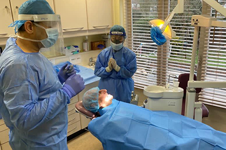 Dr Madin Khan and dental nurse in full PPE